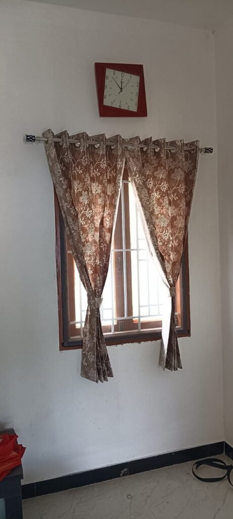 Floral eyelet curtains with tiebacks