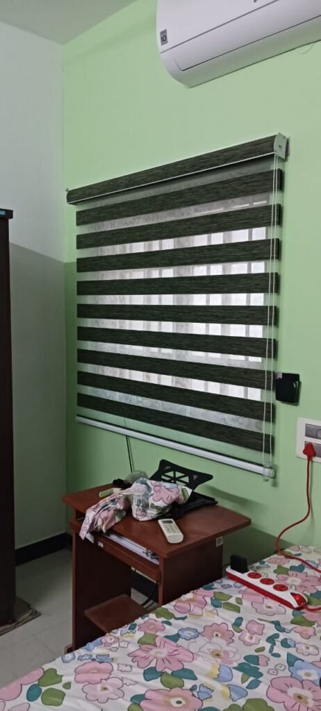 Green zebra blind in a bedroom