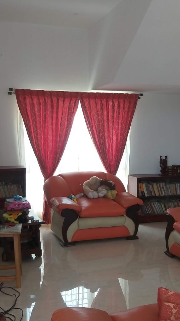 Red eyelet curtains in a living room