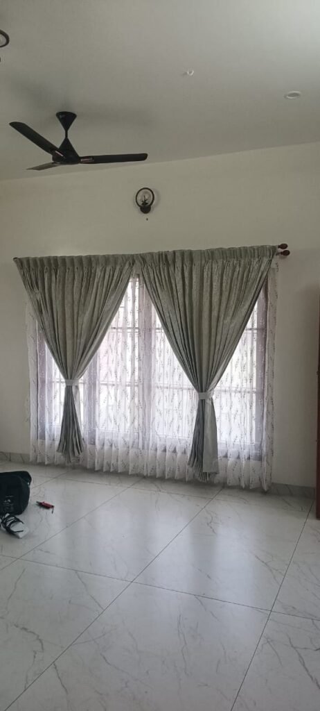 Sheer curtains with tiebacks on a large window